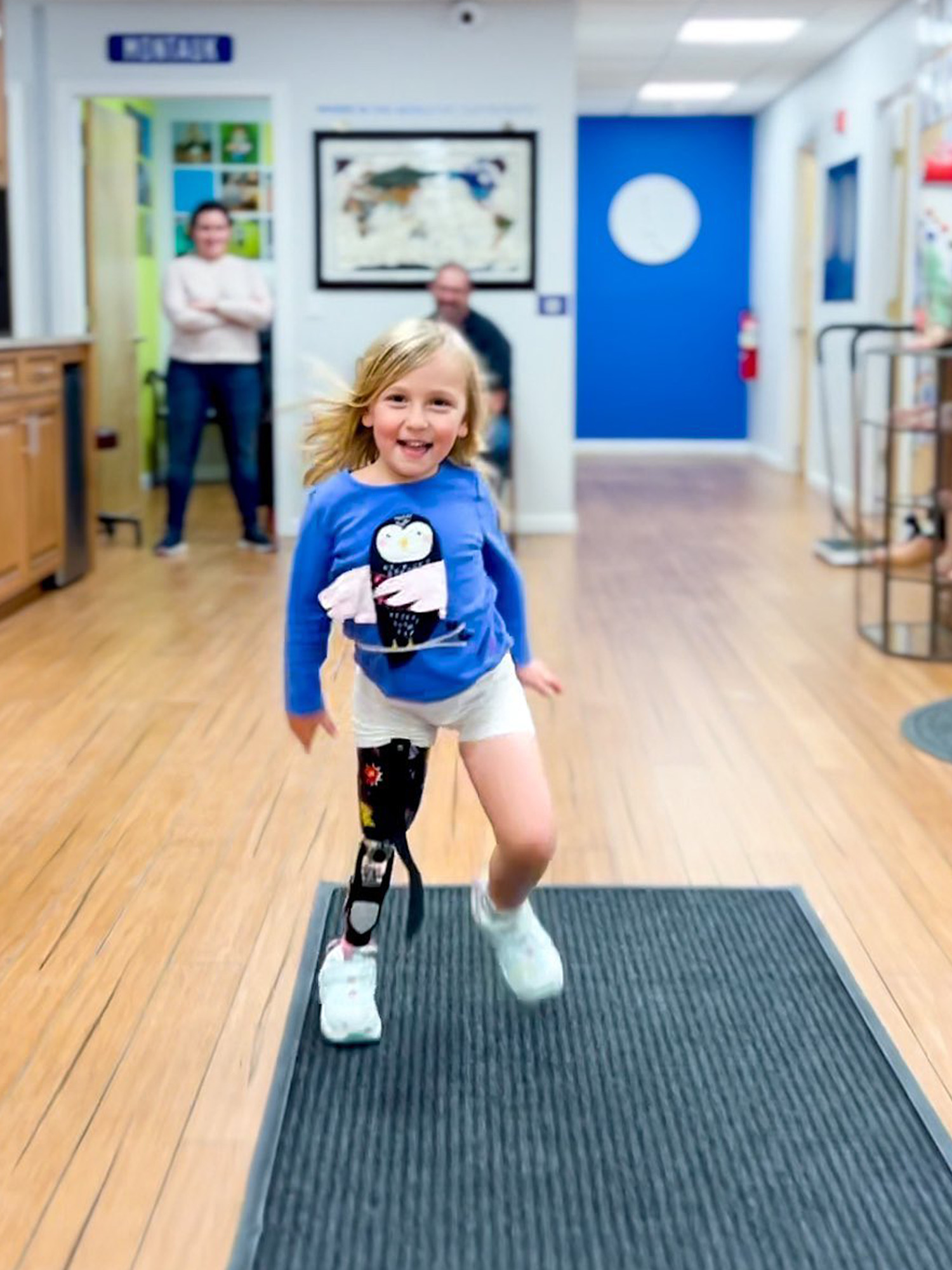 An inspiring image of a young child with an above knee amputation running effortlessly, displaying her remarkable adaptability and determination.
