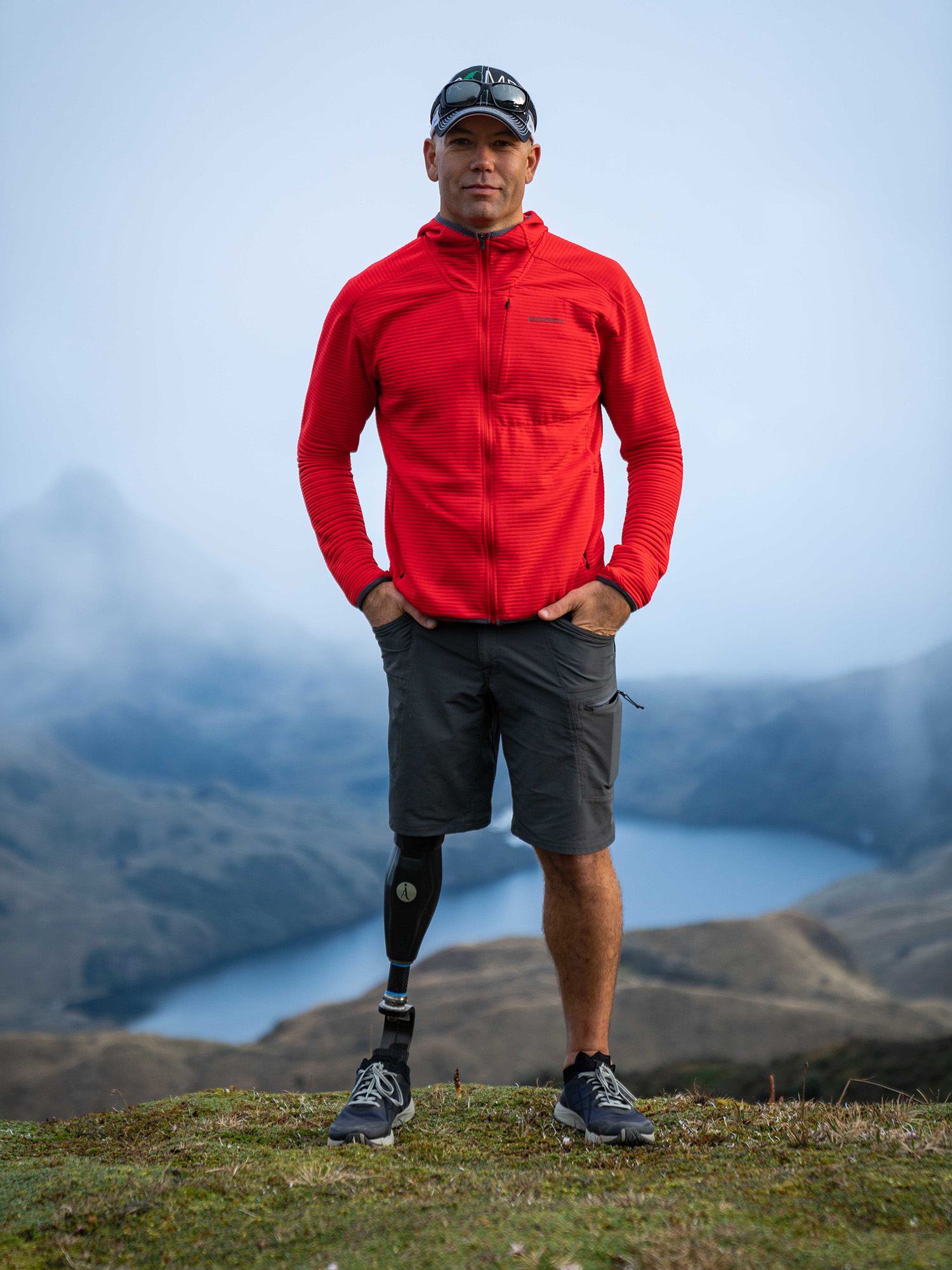 a person with prosthetic leg standing on a rock