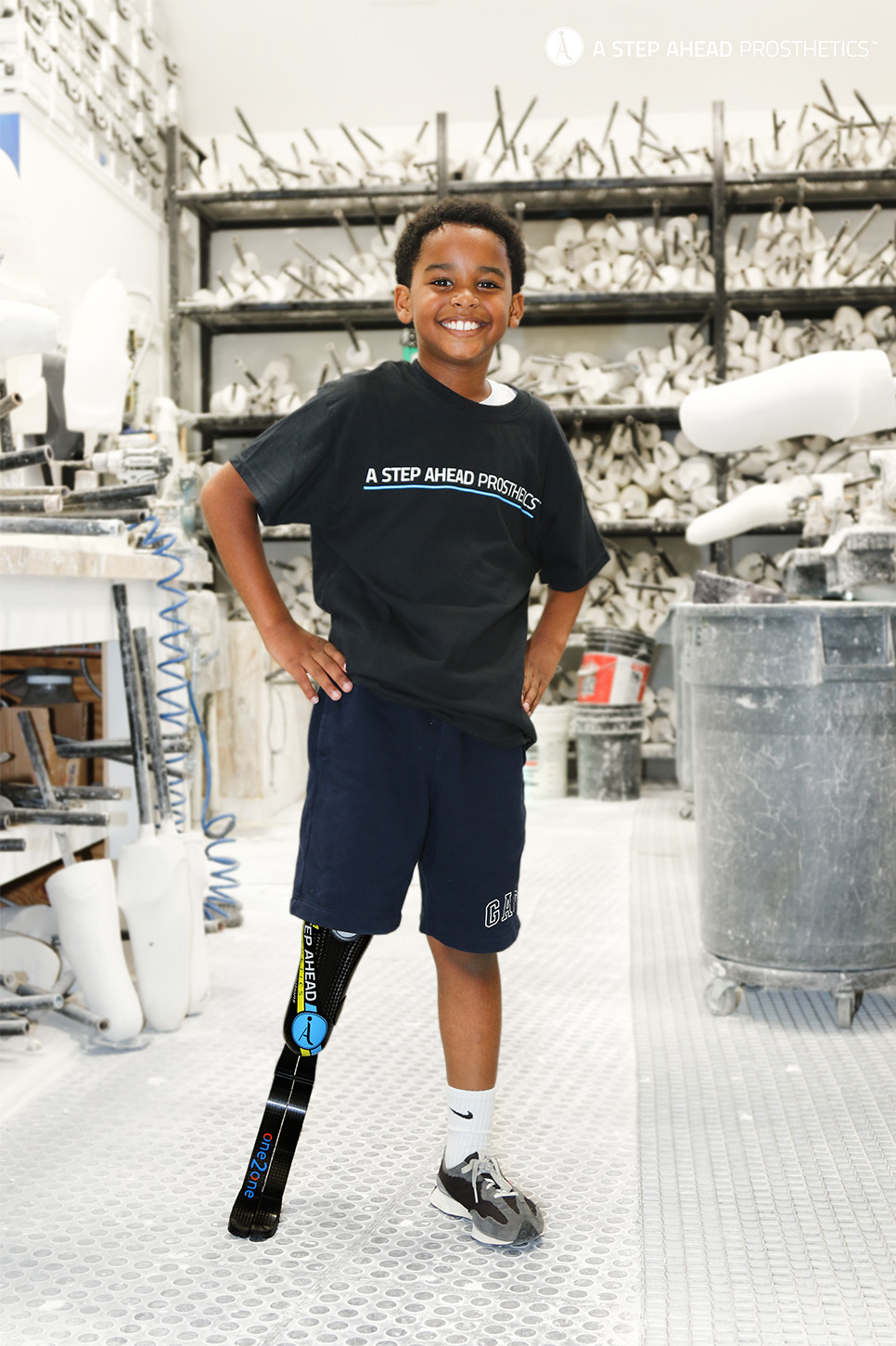 A young male with a prosthetic leg stands confidently